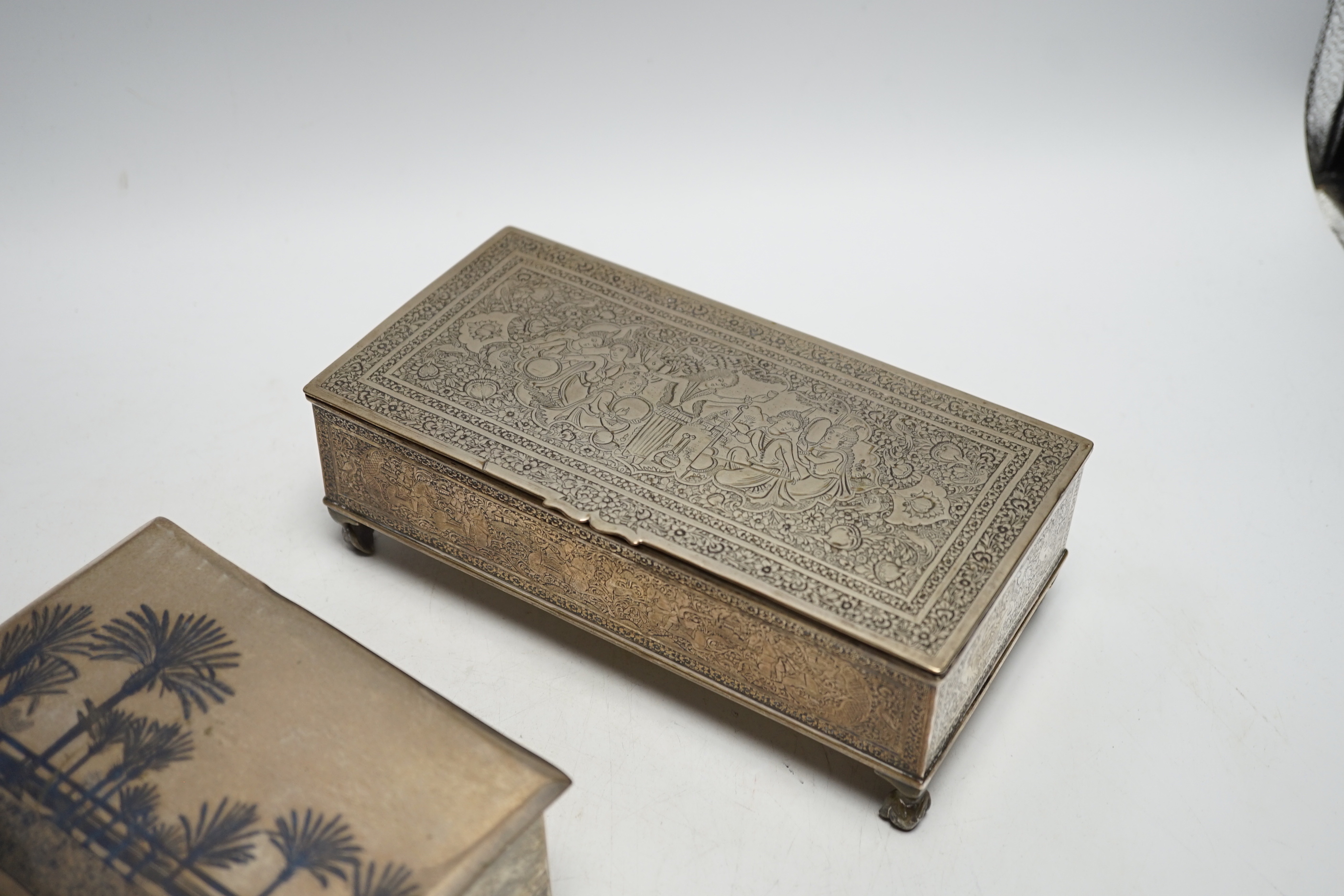 A Persian engraved white metal rectangular cigarette box and a similar white metal and niello cigarette box, largest 20.3cm.